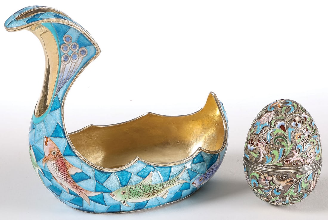 THREE RUSSIAN SILVER & ENAMEL ITEMS: THREE RUSSIAN SILVER & ENAMEL ITEMS. Comprising an Art Nouveau-style silver-gilt and enameled kovsh decorated with fish against geometric flowing water, the underside bearing Cyrillic pseudo maker's m