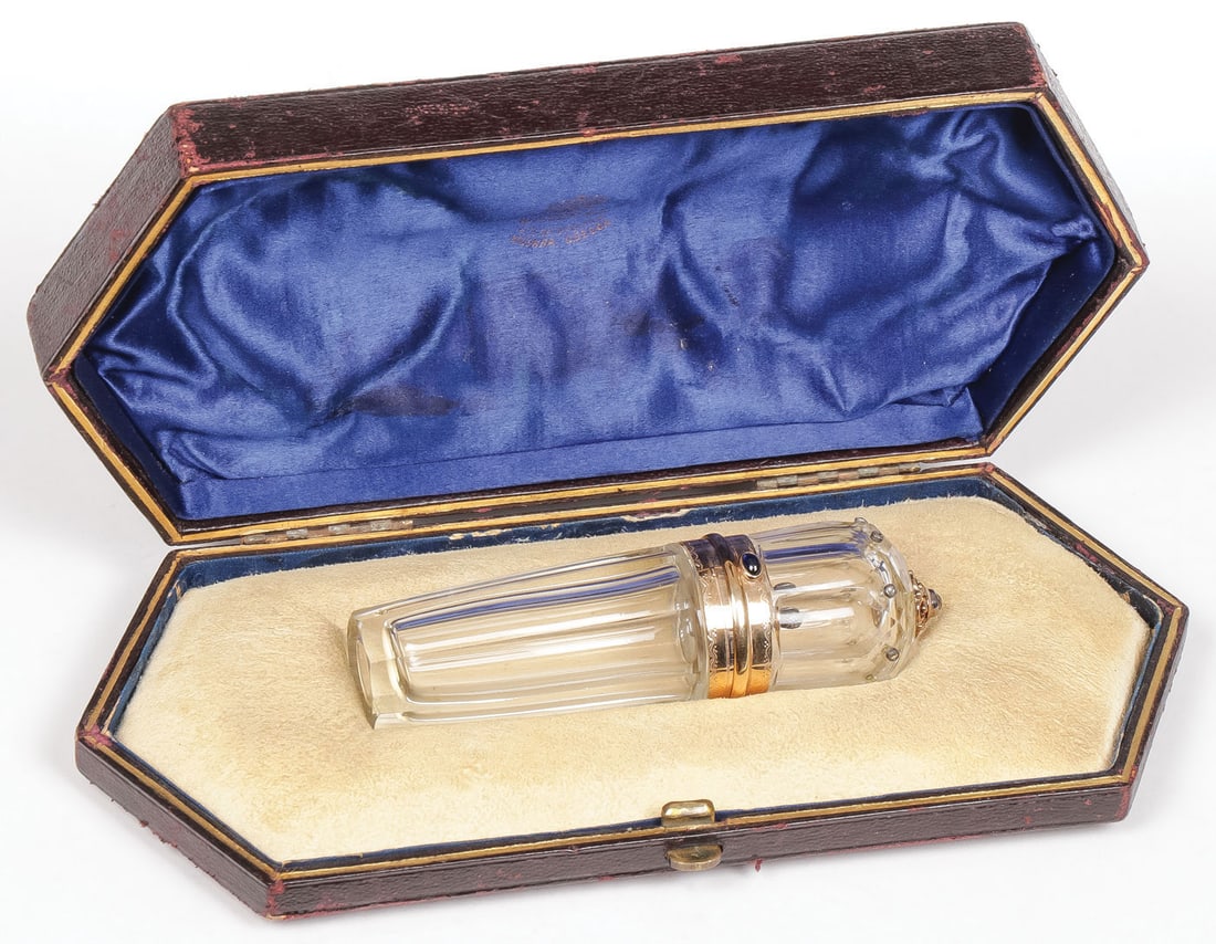 A FABERGE STYLE CRYSTAL & DIAMOND PERFUME: A FABERGE STYLE CRYSTAL & DIAMOND PERFUME. Comprising a two-piece faceted crystal perfume bottle. The hinged lid set with accent diamonds and with rose cut diamond finial, gold banded collar, blue