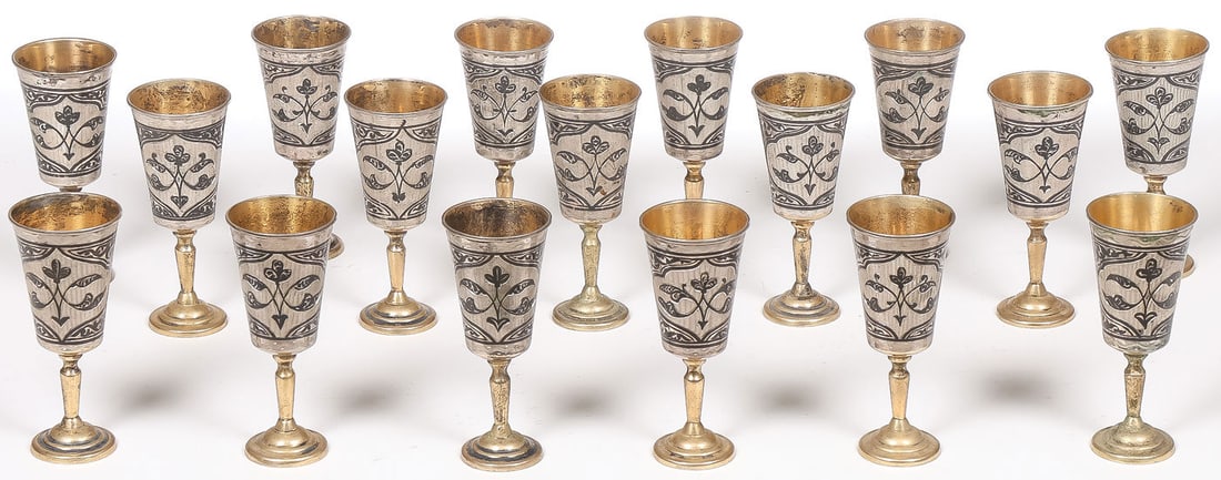 17 RUSSIAN SILVER & NIELLO FOOTED CORDIALS: 17 RUSSIAN SILVER & NIELLO FOOTED CORDIALS. Comprising 17 matching Russian (Soviet period) silver-gilt and niello footed cordials, each stamped with the .875 Soviet silver standard and the city mark