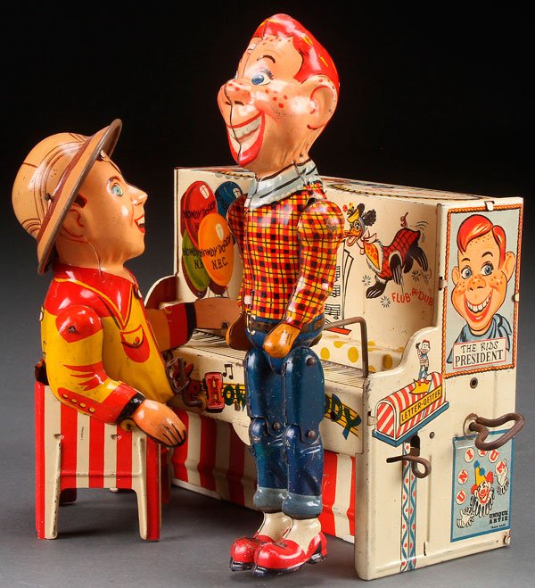 A UNIQUE ART HOWDY DOODY AND BOB SMITH BAND TOY,: A UNIQUE ART HOWDY DOODY AND BOB SMITH BAND TOY, MID 20TH CENTURY. Tin litho wind up. Height 8.75 inches (22 cm).
