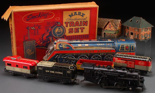 A MARX MECHANICAL TOY TRAIN SET: A MARX MECHANICAL TRAIN SET, MID 20TH CENTURY. Together with a Japan tin litho battery locomotive and two paper litho train buildings. Largest length 16 inches (41 cm).