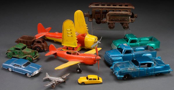 A CAST IRON AND DIE CAST TOY GROUP: A CAST IRON AND DIE CAST TOY GROUP, EARLY TO MID 20TH CENTURY. Eleven pieces, comprising two cast iron train cars, a cast iron sedan, two Hubley airplanes, three Structo vehicles, a dump truck and oth