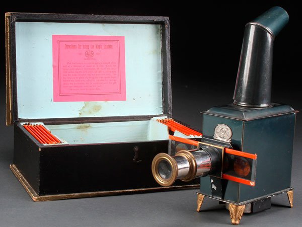 A GERMAN TOY MAGIC LANTERN TOY WITH SLIDES: A GERMAN TOY MAGIC LANTERN, LATE 19TH CENTURY. In original box with slides, marked Standard E.P, box length 10.5 inches (26.5 cm).