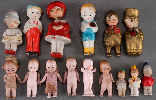 A GROUP OF 13 GERMAN BISQUE MINIATURE DOLL FIGURE: A GROUP OF 13 GERMAN BISQUE MINIATURE DOLL FIGURES, EARLY 20TH CENTURY. Of various types including four nodders and a full figure pin cushion babe doll. Together with two Japan Skippy type dolls. Larg