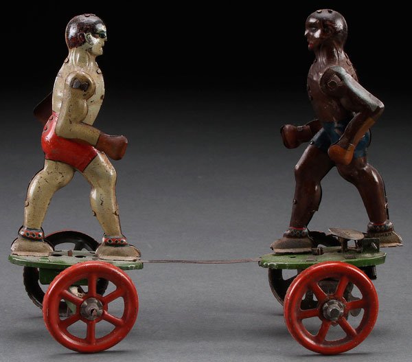 A BLACK AMERICANA GERMAN TIN LITHO TOY CLOCKWORK BOXER: A BLACK AMERICANA TIN LITHO CLOCKWORK BOXER, EARLY 20TH CENTURY. Einfault, Germany of a black and white boxer, possibly Joe Louis and Max Schmelling. Length 7 inches (18 cm).