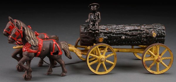 A BLACK AMERICANA KENTON CAST IRON LOG WAGON: A BLACK AMERICANA KENTON CAST IRON LOG WAGON, EARLY 20TH CENTURY. With two horse team pulling a log driven by a black man. Length 15 inches (38 cm).