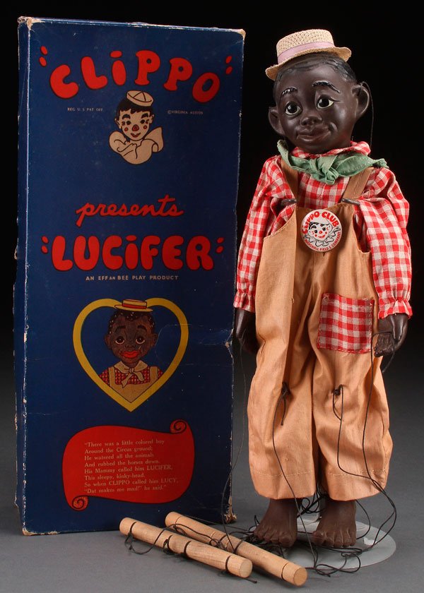 A BLACK AMERICANA CLIPPO CLOWN LUCIFER PUPPET DOLL TOY: A BLACK AMERICANA CLIPPO LUCIFER PUPPET DOLL, CIRCA 1930S. Near mint condition, in original box with Marshall Field and Co. Clippo Club button. Made by Effanbee. Length of box 15.25 inches (39 cm).