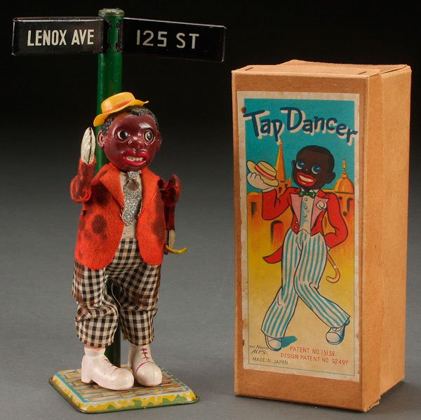 A BLACK AMERICANA ALPS JAPAN CELLULOID TIN WIND UP TOY: A BLACK AMERICANA ALPS JAPAN CELLULOID AND TIN WIND-UP "TAP DANCER" IN ORIGINAL BOX, MID 20TH CENTURY. Height of figure 8.25 inches (21 cm).