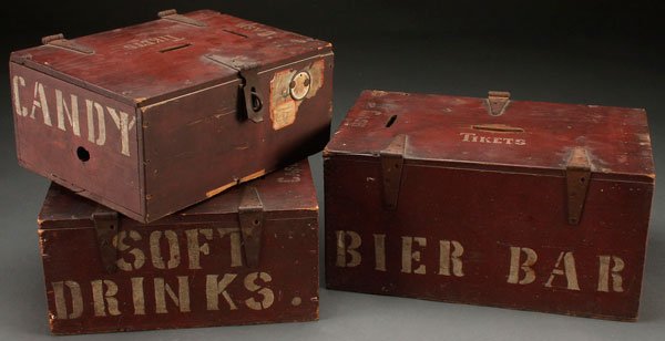 A GROUP OF THREE AMERICANA PRIMITIVE TICKET CASH BOXES: A GROUP OF THREE AMERICANA PRIMITIVE TICKET CASH CARNIVAL BOXES, EARLY 20TH CENTURY. Each with original red paint and white stenciled lettering for "Bier Bar", "Soft Drinks" and "Candy", the hinged li