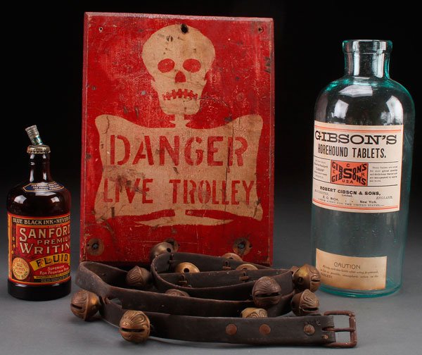 DECORATIVE PRIMITIVES AND ADVERTISING: A LATE 19TH/EARLY 20TH CENTURY DECORATIVE PRIMITIVES GROUP. Comprising a polychrome wood electric trolley warning sign, a Gibson's Horehound Tablet jar, A Sanford's ink bottle, and a 14 brass bell str