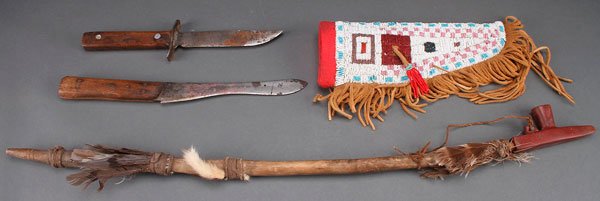 A BEADED HIDE KNIFE CASE WITH FRINGE: A BEADED HIDE KNIFE CASE WITH FRINGE. Length 10 inches; together with a catlinite pipe bowl (length 4 inches), mounted on a later stem; and two vintage knives.