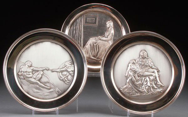 THREE STERLING SILVER COLLECTORS PLATES 34.6 TROY OZ: THREE STERLING SILVER COLLECTORS PLATES, LATE 20TH CENTURY. Comprising a sterling embossed Pieta and Adam after Michelangelo, and a Washington mint Whistler's Mother. The largest diameter 9 inches. We