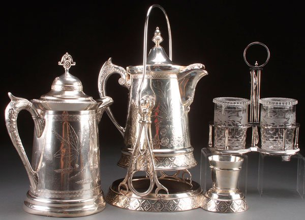 A FINE GROUP OF VICTORIAN SILVER PLATED TABLEWARE: A FINE GROUP OF VICTORIAN SILVER PLATED TABLEWARES. Comprising a tilting ice water pitcher, a single ice water pitcher, and a double pickle castor with etched glass inserts. The largest height 17.5 in