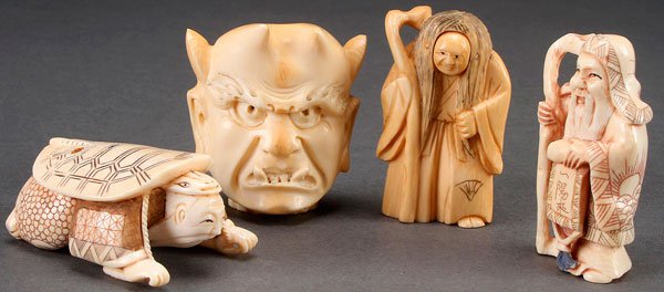 A GROUP OF FOUR JAPANESE CARVED IVORY NETSUKES: A GROUP OF FOUR JAPANESE CARVED IVORY NETSUKES, 20TH CENTURY. Comprising a figure with staff and rotating face, a bearded figure with turtle shell on back, a grotesque facial form of Oni, and an immor