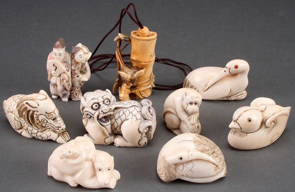 NINE JAPANESE CARVED IVORY NETSUKES: NINE JAPANESE CARVED IVORY NETSUKES, EARLY TO MID 20TH CENTURY. Of various form and shape including birds, mythical beasts, monkeys and entertainers. The largest 2 inches (5 cm).