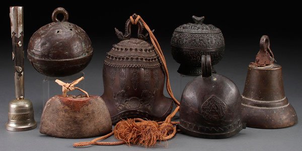 A CHINESE AND MIDDLE EASTERN BRONZE BELL GROUP: A CHINESE AND MIDDLE EASTERN BRONZE BELL GROUP, 19TH/20TH CENTURY. Comprising an archaic style temple bell with embossed designs and double dragon form handle, a flared bell with wrought iron attachme