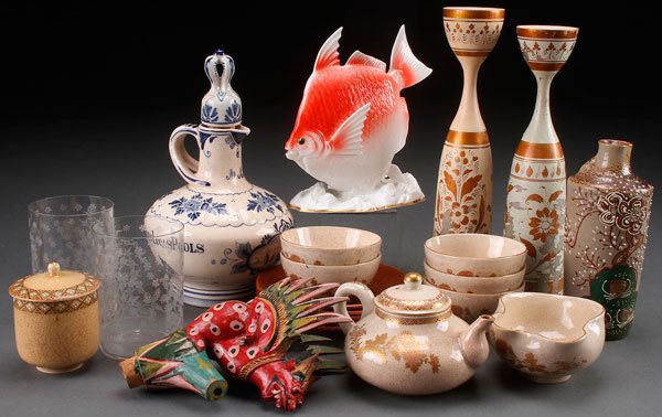 A 22 PIECE GROUP OF ORIENTAL AND MIXED CULTURE ARTS: A 22 PIECE GROUP OF ORIENTAL AND MIXED CULTURE DECORATIVE ARTS, 19TH/20TH CENTURY. Comprising a Noritake figural goldfish, Satsuma teapot with creamer and five cups, five turned wood saucers, a carved