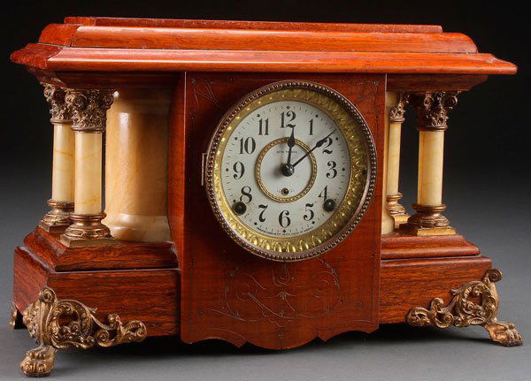 A SETH THOMAS MANTLE CLOCK,: A SETH THOMAS MANTLE CLOCK, LATE 19TH CENTURY. With faux alabaster and spelter mounts. Length 17.5 inches (44 cm).
