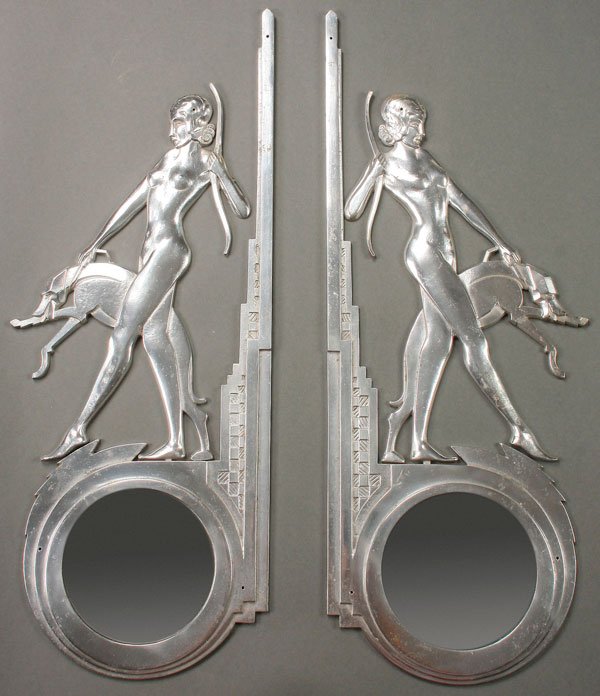 A PAIR OF CAST ALLUMINUM MIRRORED WALL BRACKETS,: A PAIR OF CAST ALLUMINUM MIRRORED WALL BRACKETS, 20TH CENTURY. Each depicting nude archers with dogs, standing above a convex circular mirror. Height 26 inches (66 cm).