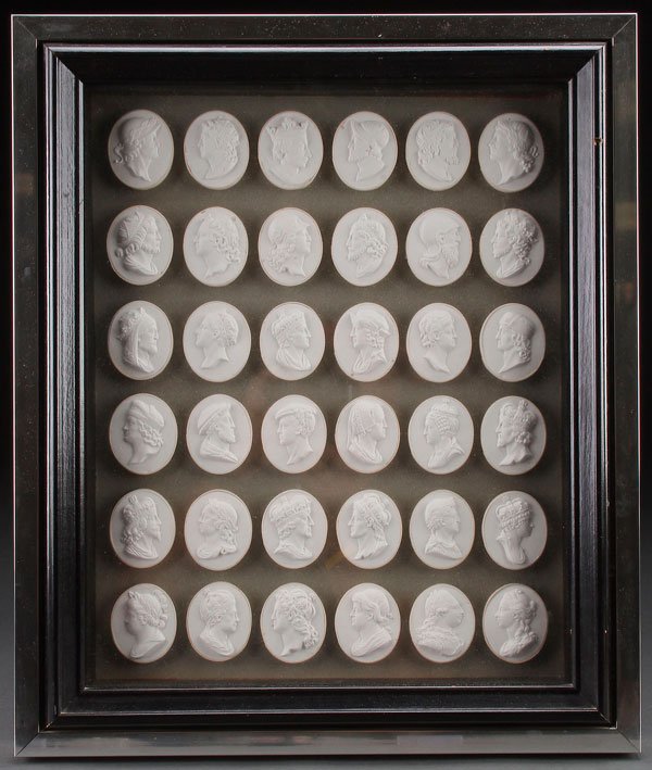 A MONARCHS OF ENGLAND CAMEO PORTRAIT GROUPING,: A MONARCHS OF ENGLAND CAMEO PORTRAIT GROUPING, 20TH CENTURY. Comprising 36 different cast plaster relief portraits, contained within a contemporary shadow box frame. 19.5 inches x 16.5 inches (50 x 42