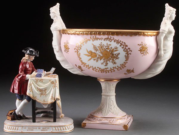 A DECORATIVE PORCELAIN GROUP, 20TH CENTURY.: A DECORATIVE PORCELAIN GROUP, 20TH CENTURY. Comprising a large Japanese porcelain compote with bisque figural handles in the Sevres style, and a Ludwigsburg figural group of a young gentleman building