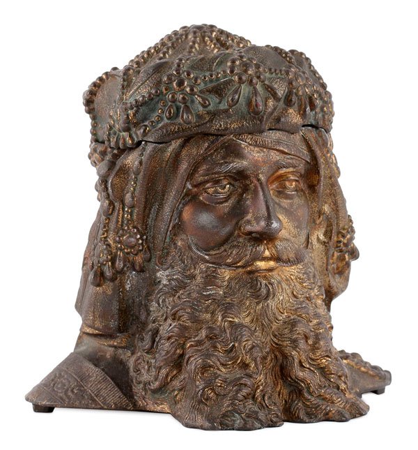 RUSSIAN BOGATYR STYLE HUMIDOR: A PARTIAL GILT METAL FIGURAL HUMIDOR OF A RUSSIAN BOGATYR STYLE HEAD, 19TH CENTURY. The hinged lid opening to reveal a tobacco reservoir. Hinge pin absent. Underside marked Bradley and Hubbard. Height