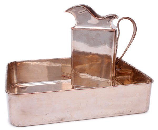 AN IMPERIAL RUSSIAN SILVERED PARTIAL WASH SET: AN IMPERIAL RUSSIAN SILVERED PARTIAL WASH SET, PERIOD OF NICHOLAS I. Comprising a deep silver plated copper basin with rounded corners and a large water pitcher with removable handle. The pitcher with