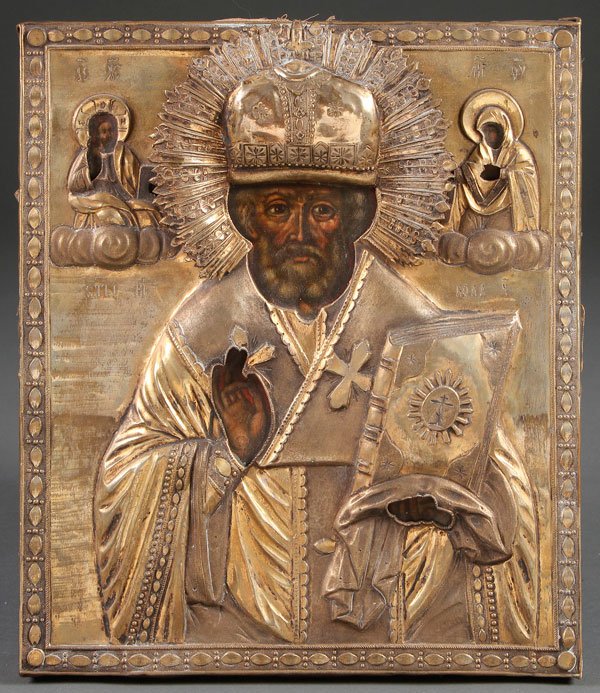 A RUSSIAN ICON OF ST. NICHOLAS, 18TH CENTURY: A RUSSIAN ICON OF ST. NICHOLAS, 18TH CENTURY. With ornate repoussé and chased silver plated riza. 11.8 inches x 10.25 inches (30.1 x 26 cm).