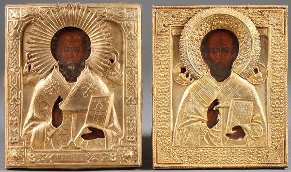 TWO RUSSIAN ICONS OF SAINT NICHOLAS: A PAIR OF RUSSIAN ICONS, EACH DEPICTING ST. NICHOLAS, 19TH CENTURY. Each overlaid with a silver and gold washed riza. 10.5 inches x 8.5 inches (26.6 x 21.5 cm) and 10.25 inches x 8.5 inches (26 x 21.5