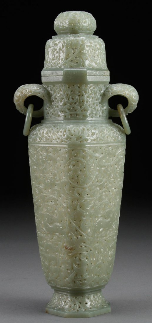 A LARGE CHINESE MUGHAL CARVED CELADON JADE LIDDED URN: A LARGE AND IMPRESSIVE CHINESE MUGHAL CARVED CELADON JADE LIDDED URN. Of elongated squared form, with finely reticulated scrolled foliates and mythical beasts below suspended loose ring handles. Heigh