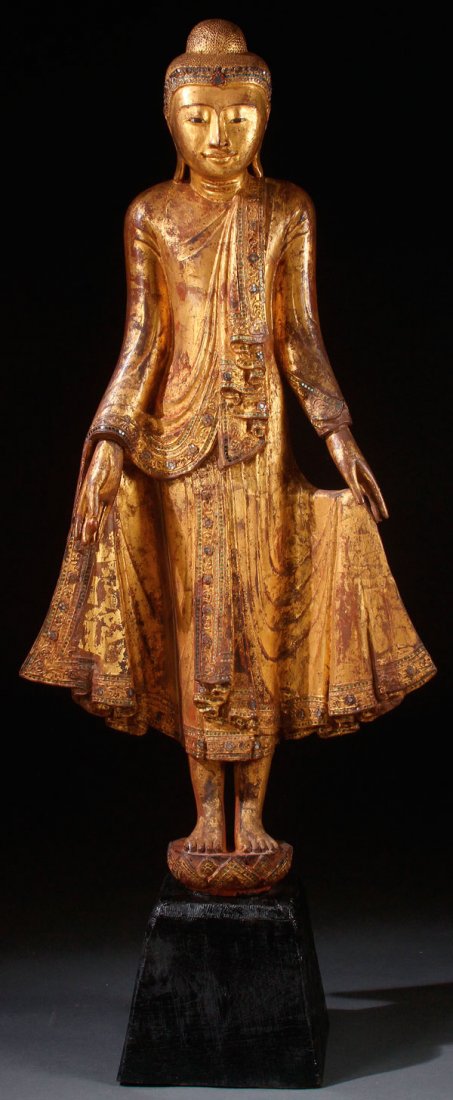 A CARVED GILT WOOD TAIWANESE BUDDHIST FIGURE: A CARVED GILT WOOD TAIWANESE BUDDHIST FIGURE. Embellished with paste stones and glass eyes. Height of figure 50 inches (127 cm), overall height 61 inches (154.9 cm).