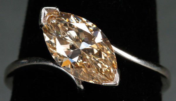 LADIES 1.86 CT "CHAMPAGNE" DIAMOND SOLITAIRE RING: A LADIES 1.86 CT "CHAMPAGNE" DIAMOND SOLITAIRE RING, 20TH CENTURY. The single Marquise cut diamond weighing approx. 1.86 ct. of light brownish yellow color and VVS-2 clarity set in a 14k white gold mo
