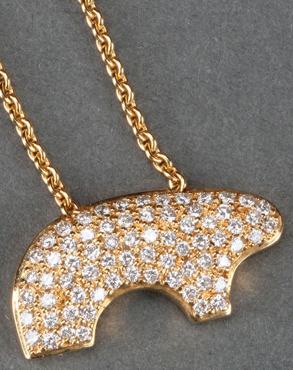 AN 18K GOLD AND DIAMOND PAVÉ "MAMA BEAR" PENDANT,: AN 18K GOLD AND DIAMOND PAVÉ "MAMA BEAR" PENDANT, CIRCA 1993. The stylized form of a bear set with 70 matching full cut diamonds, approx. vs/si clarity with a total weight of 1.12 ct., and suspended 