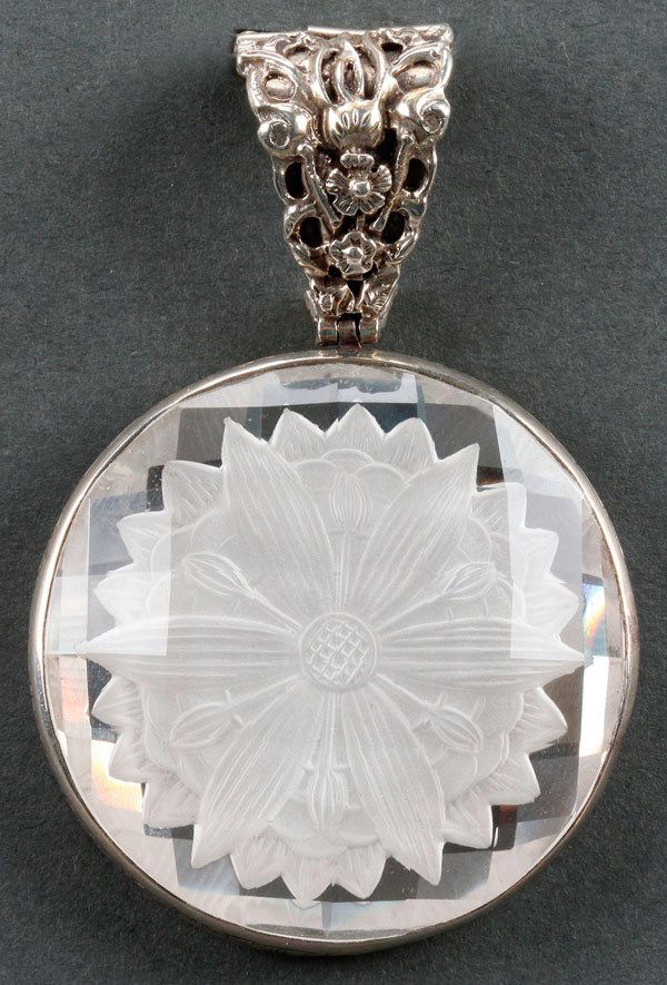 STEPHEN DWECK "ARCTIC" CRYSTAL & STERLING PENDANT: A STEPHEN DWECK "ARCTIC" ETCHED CRYSTAL AND STERLING PENDANT, LAST QUARTER 20TH CENTURY. With a frosted rosette under a multi-faceted surface set in a silver frame with embossed birds and blossoms. Th