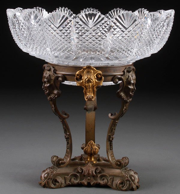 A VICTORIAN GILT BRONZE AND CUT GLASS COMPOTE: A VICTORIAN PATINATED, GILT BRONZE AND CUT GLASS COMPOTE, PROBABLY ENGLISH, THIRD QUARTER 19TH CENTURY. With pineapple pattern cut bowl raised on a three legged bronze stand with facial mask terminals