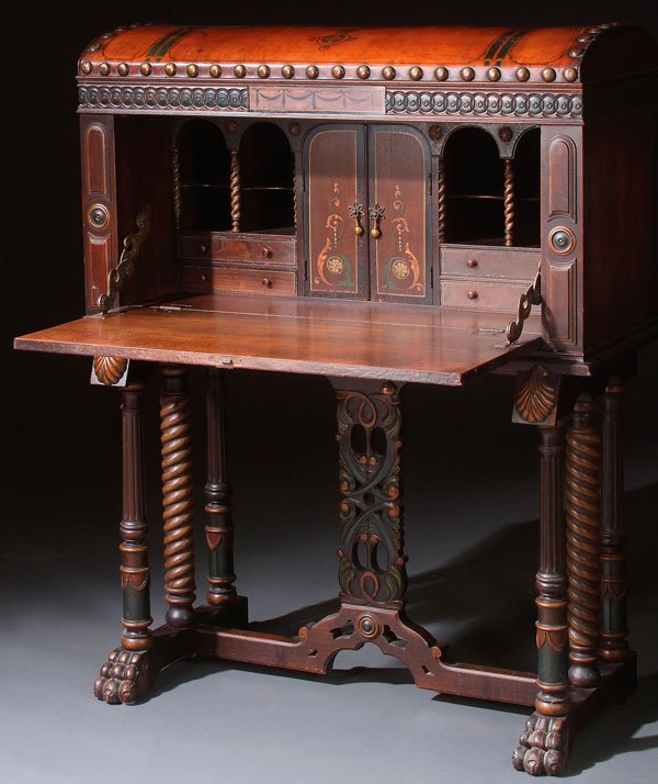 A SPANISH STYLE CARVED WOOD & POLYCHROME DESK: A SPANISH STYLE CARVED WOOD AND POLYCHROME VARGUENO DESK, CIRCA 1930S. In the form of a coffer with hinged and tooled leather covered domed lid above a drop front section desk with pigeon hole compart