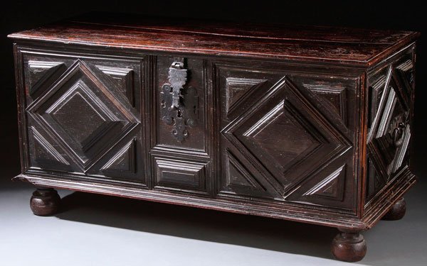 ENGLISH SIX PLANK WALNUT CHEST, 19TH C. & EARLIER: AN ENGLISH SIX PLANK WALNUT CHEST, 19TH CENTURY & EARLIER IN THE 16TH CENTURY STYLE. With applied mitred geometric moldings and wrought iron hardware, raised on turned bun feet. Height 28 inches (71 c