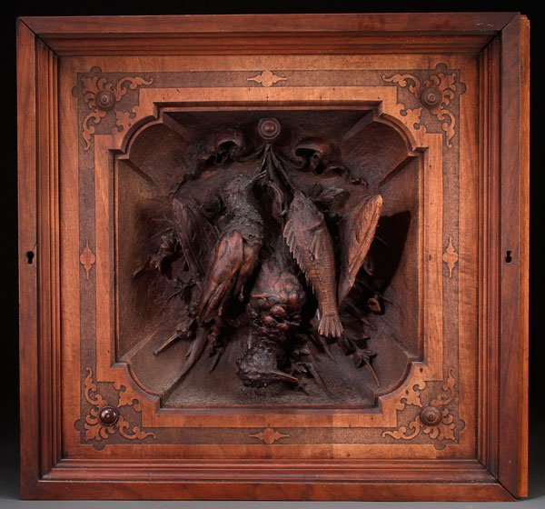 A CONTINENTAL CARVED WOOD PLAQUE, 19TH C: A CONTINENTAL CARVED WOOD PLAQUE, LATE 19TH CENTURY. Deeply carved within a shadow box recess, the three quarter round figures of two birds and a game fish with floral spray and tied ribbons. 26 inche