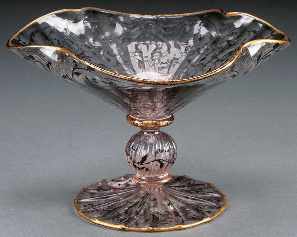 A DIMINUTIVE DAUM NANCY ENAMELED CRYSTAL COMPOTE: A DIMINUTIVE DAUM NANCY ENAMELED CRYSTAL COMPOTE, LATE 19TH CENTURY. Enameled with charcoal colored scrolled foliates, raised on a ribbed footrim with melon ball stem. Inscribed in gilt Daum Nancy wit