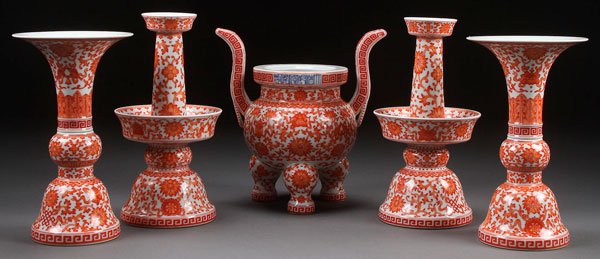 CHINESE FIVE PIECE PORCELAIN RED OXIDE ALTAR SET: A CHINESE FIVE PIECE PORCELAIN RED OXIDE ALTAR SET. Comprising an incense burner, two candlesticks and two vases, each decorated with lotus blossoms, foliage and Buddhist symbols. Each with blue under
