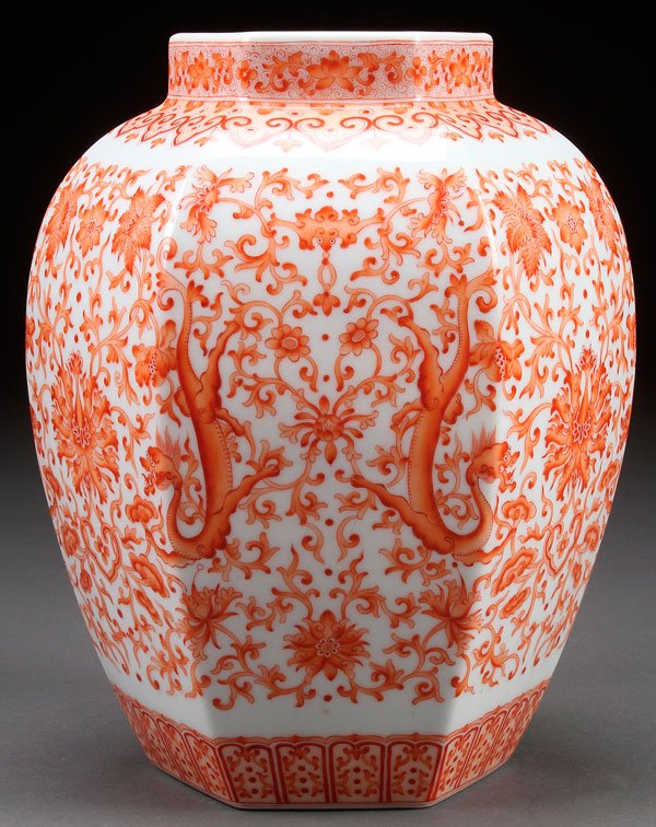 A CHINESE RED OXIDE "INTERLOCKING FLOWERS VASE: A CHINESE RED OXIDE "INTERLOCKING FLOWERS AND DRAGONS" PORCELAIN VASE. Of ovoid hexagonal form. Base with Qianlong mark. Height 8.5 inches (21.5 cm).