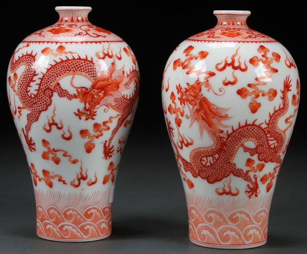 PAIR CHINESE RED OXIDE DECORATED MEIPING VASES: A PAIR OF CHINESE RED OXIDE DECORATED MEIPING "DRAGON" PORCELAIN VASES. Each with two dragons and cloud forms. Bases with Guangxu marks. Height 6.5 inches (16.5 cm).