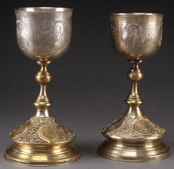 A PAIR OF RUSSIAN SILVER AND BRASS CHALICES, CIRC: A PAIR OF RUSSIAN SILVER AND BRASS CHALICES, CIRCA 1900. Overall heavily engraved and repousséd, the base of each with engraved medallions depicting the four Evangelists, and the cup engraved with th