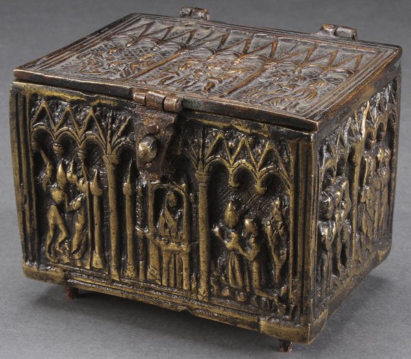 A NEOGOTHIC CAST BRONZE RELIQUARY BOX. The sides: A NEOGOTHIC CAST BRONZE RELIQUARY BOX. The sides and hinged lid with reserves depicting scenes of martyrdom beneath arched gothic elements. 3.1 inches x 4 inches x 3 inches (8 x 10.2 x 7.5 cm).