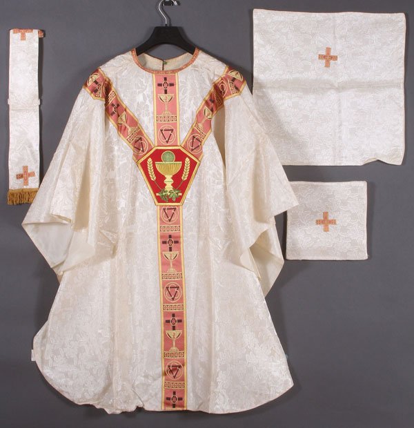 A PAIR OF EMBROIDERED CHASUBLES AND ACCOUTREMENTS: A PAIR OF EMBROIDERED CHASUBLES AND ACCOUTREMENTS, CIRCA 1920-1940'S. The white example including a burse, chalice cover and maniple. The red example including a stole, burse, chalice cover, and manip