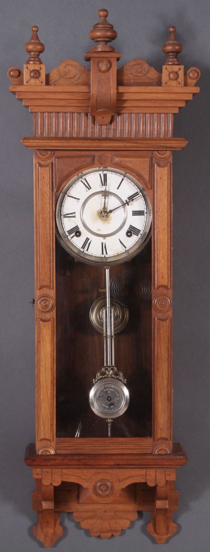 A WATERBURY WALNUT REGULATOR CLOCK, 19TH CENTURY.: A WATERBURY WALNUT REGULATOR CLOCK, 19TH CENTURY. With eight day movement and chime. Length 35 inches.