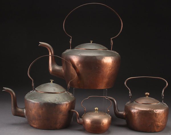 A GROUP OF FOUR EARLY AMERICAN COPPER TEA KETTLES: A GROUP OF FOUR EARLY AMERICAN COPPER TEA KETTLES, 19TH CENTURY. With swing handles and dovetailed construction. The smallest stipple inscribed "N.W.S.". Largest length 15.25 inches (38.5 cm).