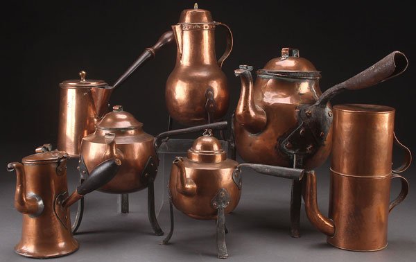 A GROUP OF SEVEN 19TH CENTURY COPPER TEA KETTLES: A GROUP OF SEVEN 19TH CENTURY COPPER TEA KETTLES AND LIQUID WARMERS. Including four with wrought iron three-legged stands, and a double teapot/cup with strainer. Largest height 16 inches (41 cm).