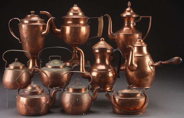 10 COPPER TEA KETTLES AND COFFEE POTS: A COLLECTION OF 10 COPPER TEA KETTLES AND COFFEE POTS, MOSTLY 19TH CENTURY. Of various size and form, one with bail handle stamped "LGL" and "AMAL". Largest height 13 inches (33 cm).