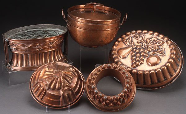 A GROUP OF FIVE ENGLISH COPPER FOOD MOLDS, 19TH C: A GROUP OF FIVE ENGLISH COPPER FOOD MOLDS, 19TH CENTURY. Comprising a large oval mold with fruit design, an oval waisted form with breakaway hinges, a ring mold, and a handled swirl mold with vented c